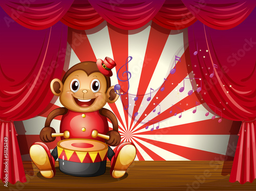 A monkey playing with a musical instrument at the stage