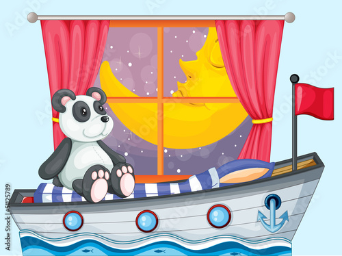 A panda sitting above the boat beside a window