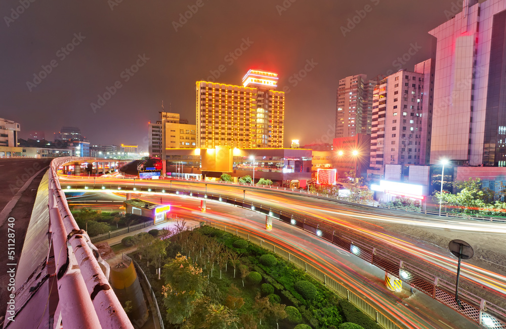 Obraz premium the light trails on the modern building in shanghai