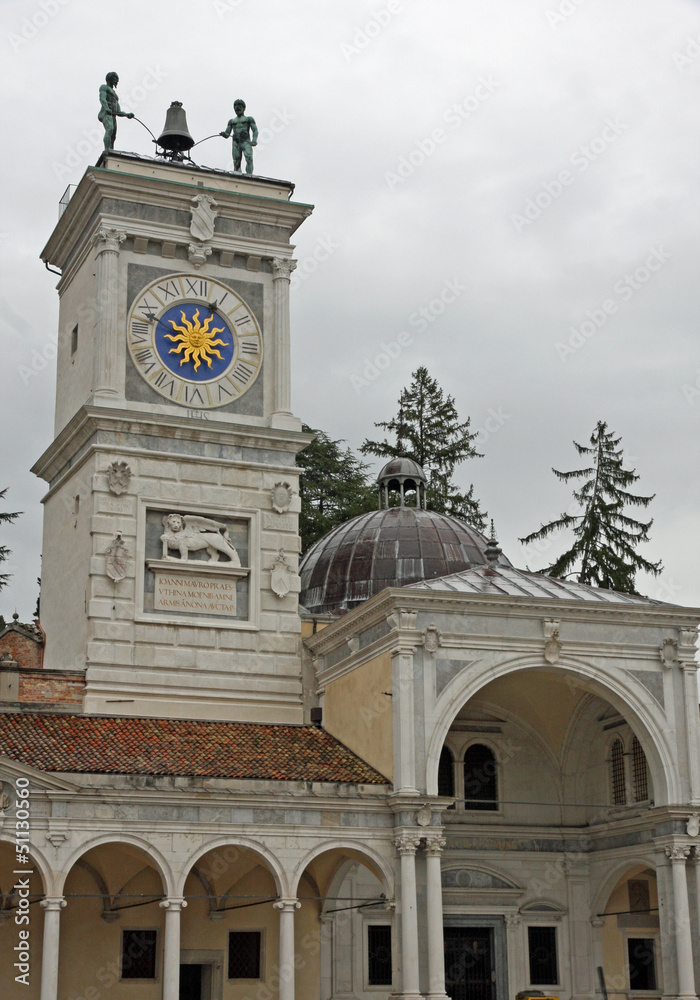 Fototapeta premium ancient Bell Tower with two African statues over flying hours in