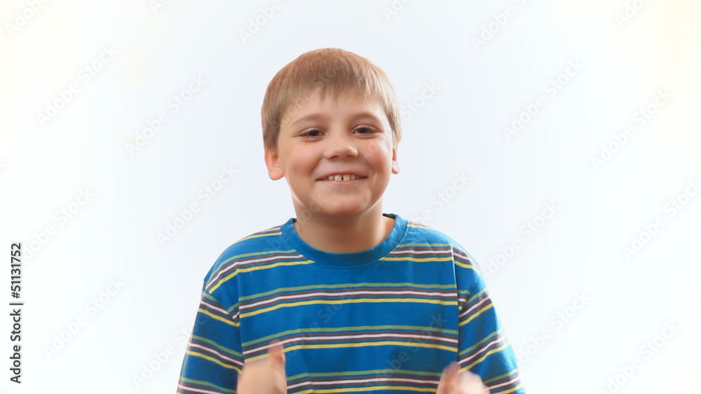 The boy laughs. Joyful happy child. Surprised boy claps The boy laughs. Joyful happy child. Surprised boy claps