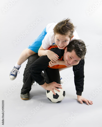 Fototapeta Naklejka Na Ścianę i Meble -  Father and son with football ball