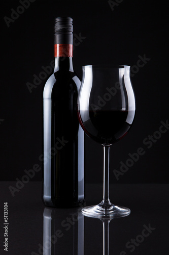 Bottle Of Wine And Glass Isolated On Black Background