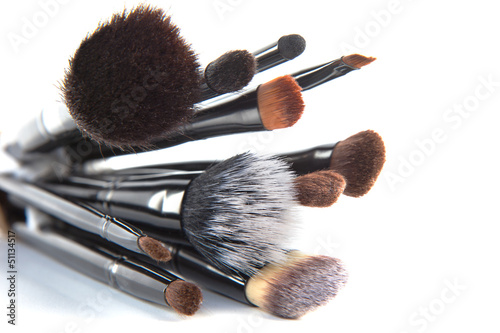 Makeup brushes on a white background