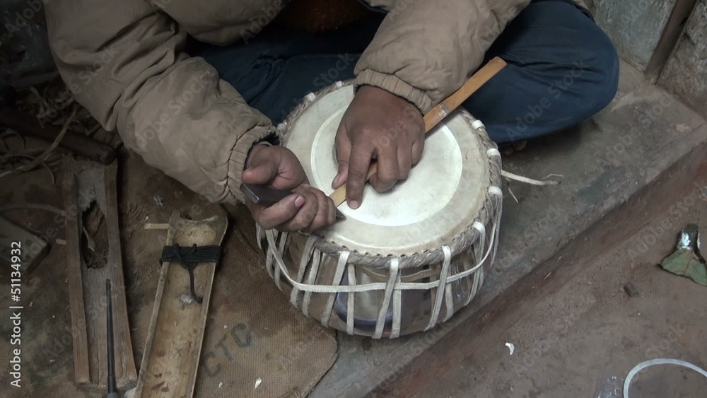 drum craftsman working with new tabla drum in Varanasi, India