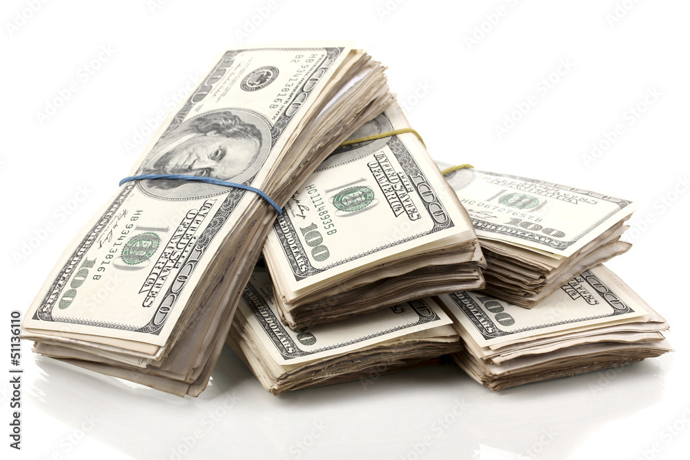 Stacks of one hundred dollars banknotes close-up isolated Stacks of one hundred dollars banknotes close-up isolated
