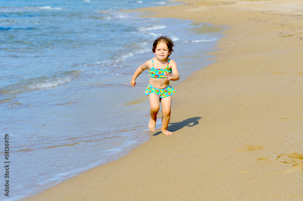 Fototapeta premium Happy toddler girl running on the beach