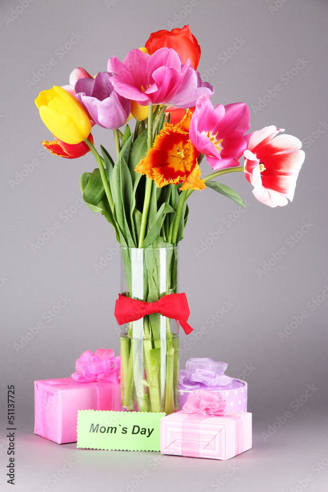 Fototapeta premium Beautiful tulips in bouquet with gifts and note