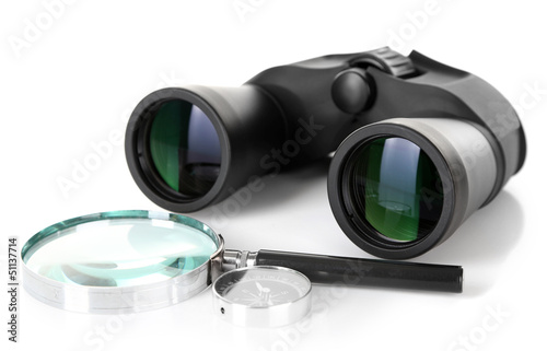 Black modern binoculars with magnifying glass and compass