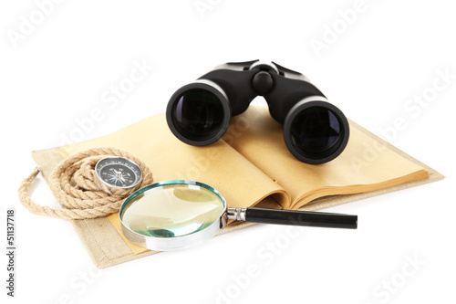Black modern binoculars with old notebook isolated on white