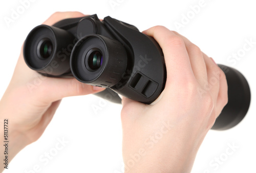 Black modern binoculars in hands isolated on white © Africa Studio