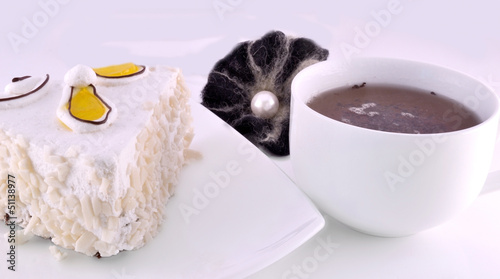 cup of tea and a slice of cake on a plate