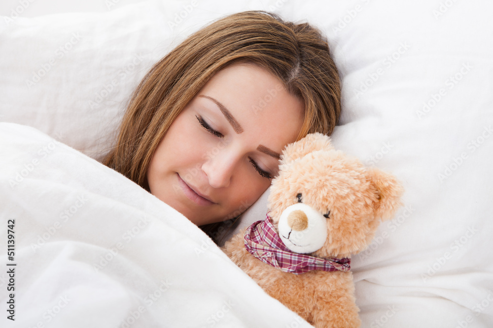 Young Beautiful Woman Sleeping On Bed With Her Teddy Bear Young Beautiful Woman Sleeping On Bed With Her Teddy Bear