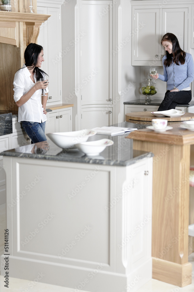 Two friends relaxing in the kitchen Two friends relaxing in the kitchen