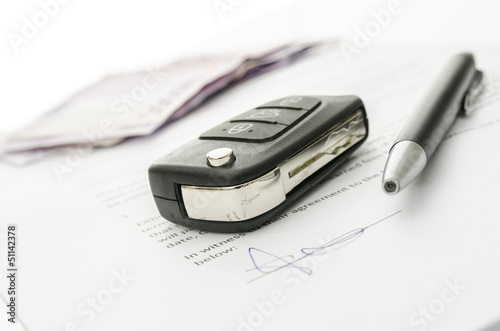 Car key on a contract of car sale