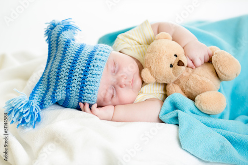 sleeping baby boy with toy
