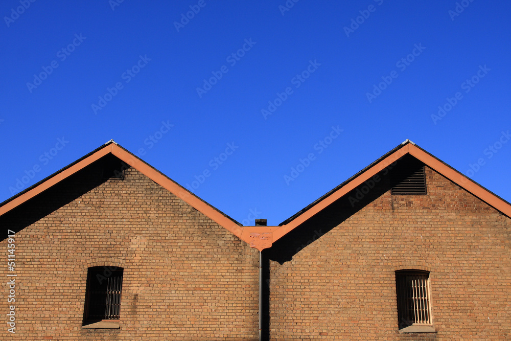 Brick wall with blue sky.