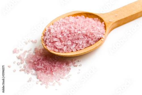 pink bath salt on wooden spoon
