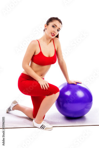 Pretty young woman with fitness ball