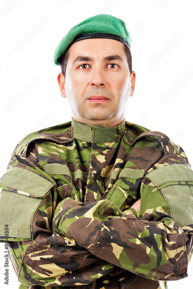 Closeup portrait of a young soldier with arms folded