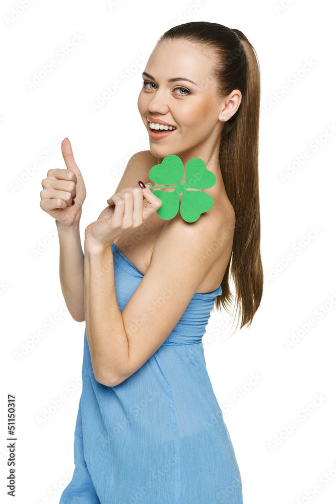 Happy woman holding shamrock leaf and showing thumb up Happy woman holding shamrock leaf and showing thumb up