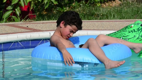 Child relaxing in swimming pool.