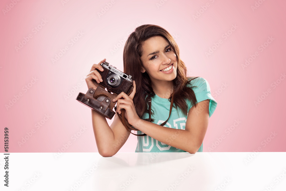 Beautiful woman with a vintage camera