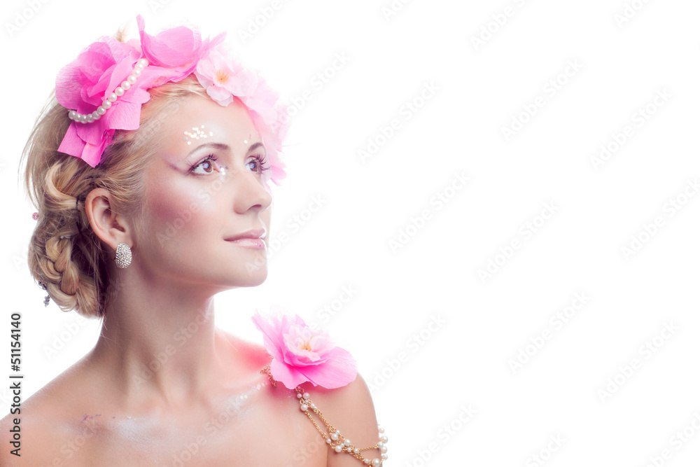A beautiful spring girl wearing flowers. Studio shot.