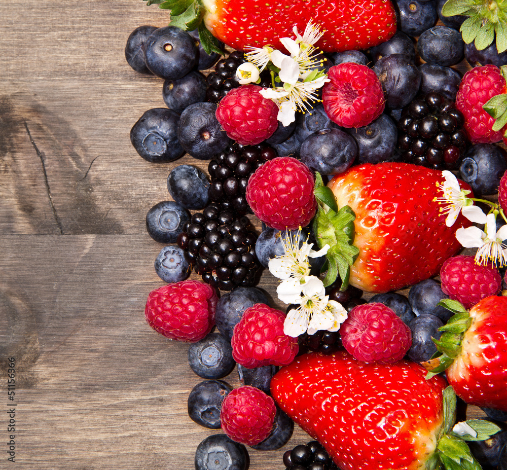 Fototapeta premium Berries on Wooden Background
