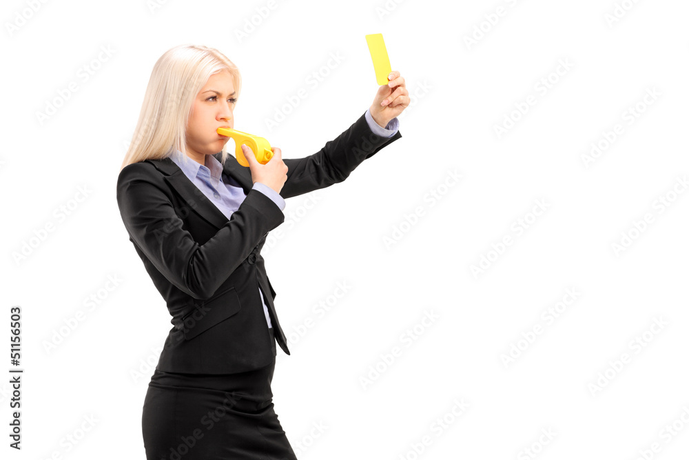 Young businesswoman blowing a whistle and showing a yellow card Young businesswoman blowing a whistle and showing a yellow card