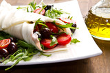 mozzarella roll with fresh tomatoes, olives and salad