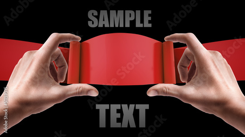 Man's hands holding red stripe isolated on black background