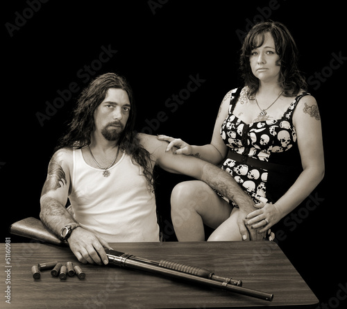 tough sexy man with tough sexy woman and a shotgun with shellson photo