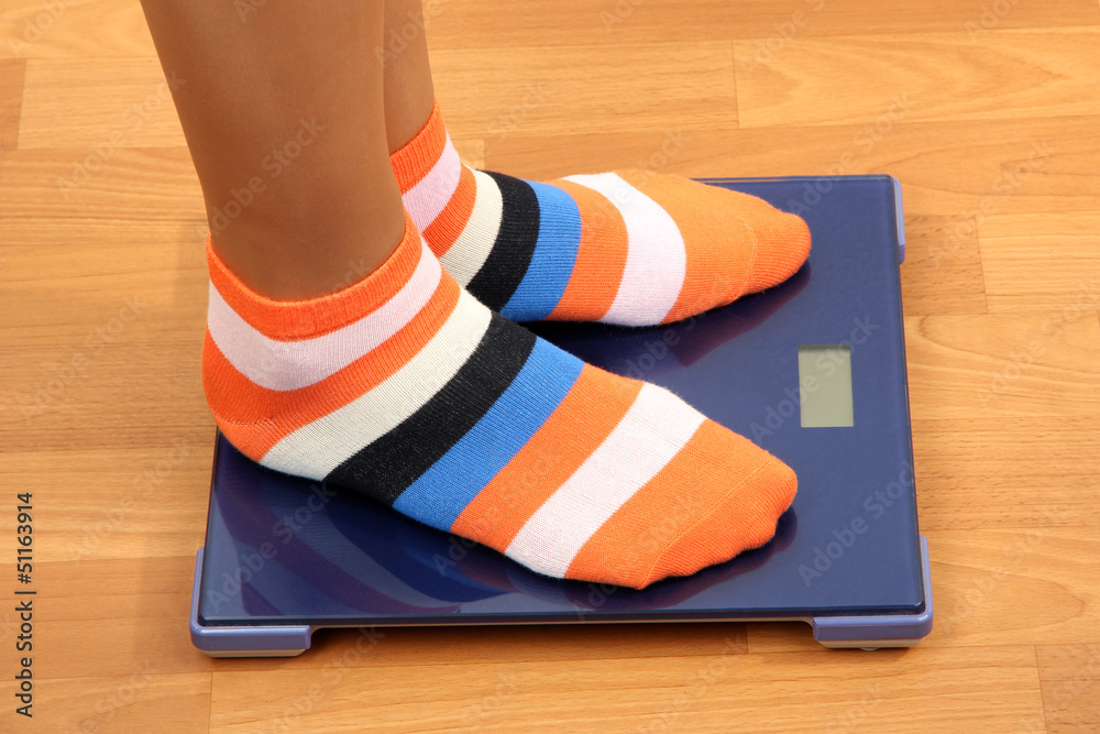Feet on scales on floor in room Feet on scales on floor in room