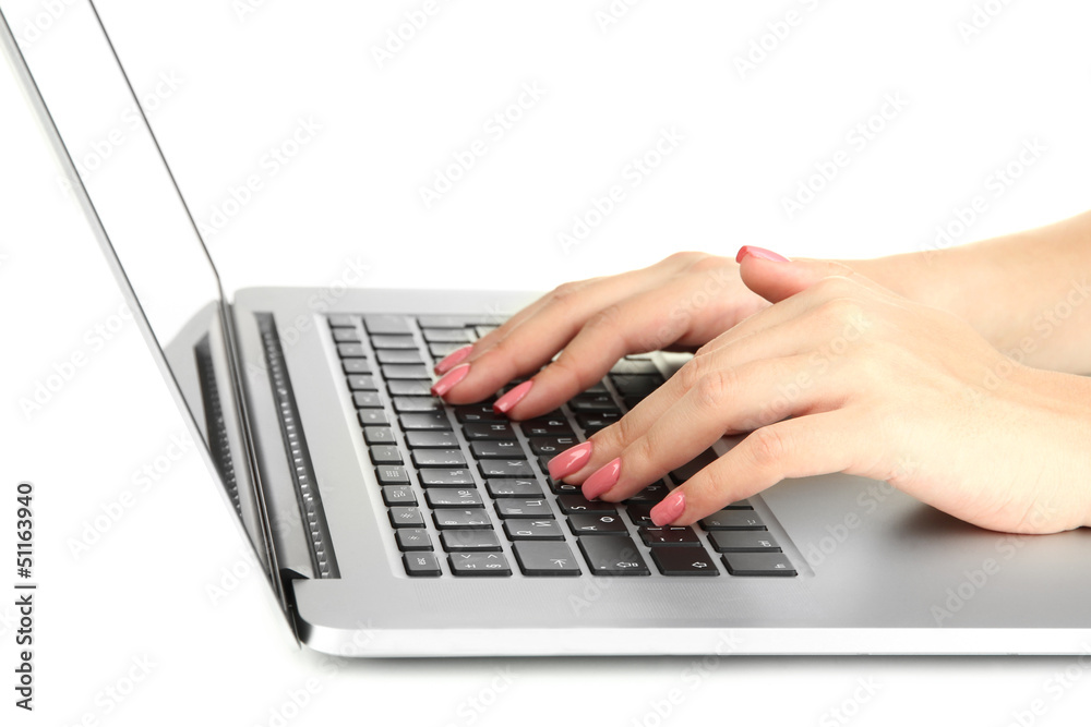 Female hands writing on laptop, isolated on white Female hands writing on laptop, isolated on white