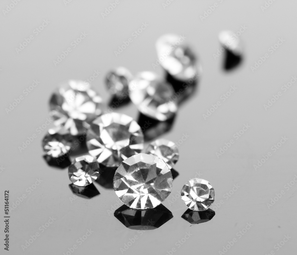 Beautiful shining crystals (diamonds), on grey background Beautiful shining crystals (diamonds), on grey background