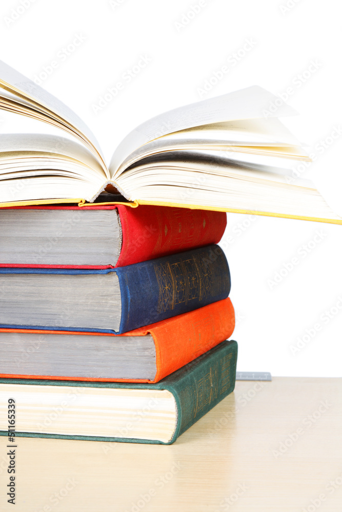A stack of multicolored thick hardcover books A stack of multicolored thick hardcover books