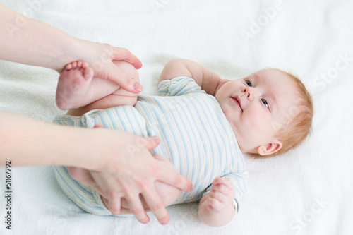 mother doing gymnastics her baby infant