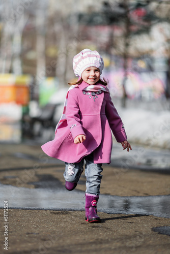 Young girl running at walkway