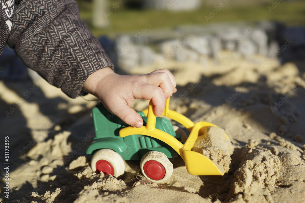 Spielen im Sandkasten mit Bagger Stock Photo | Adobe Stock