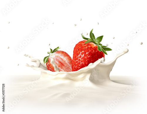 Two strawberries falling into milk splashing.