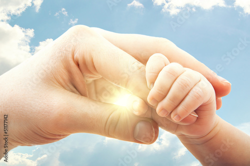 concept of love and family. hands of mother and baby