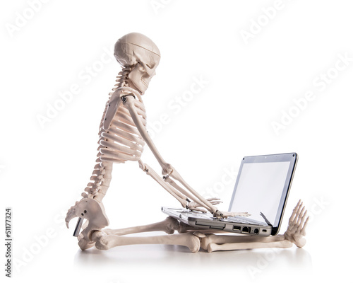 Skeleton working on laptop