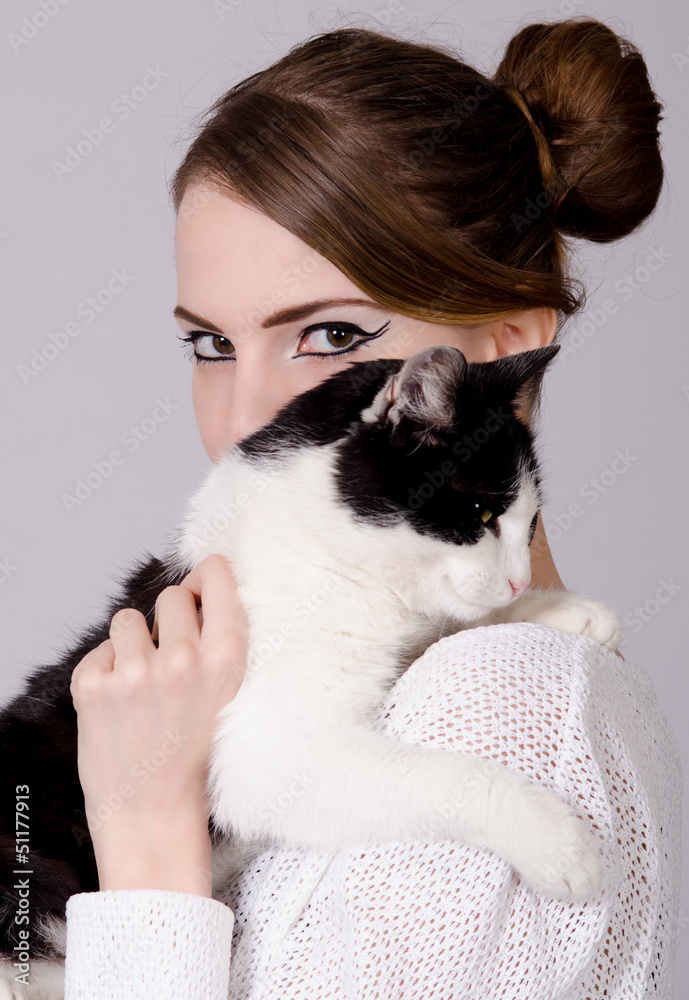 Elegant lady holding black and white cat