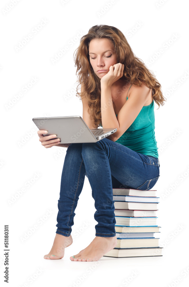 Student with netbook sitting on books Student with netbook sitting on books