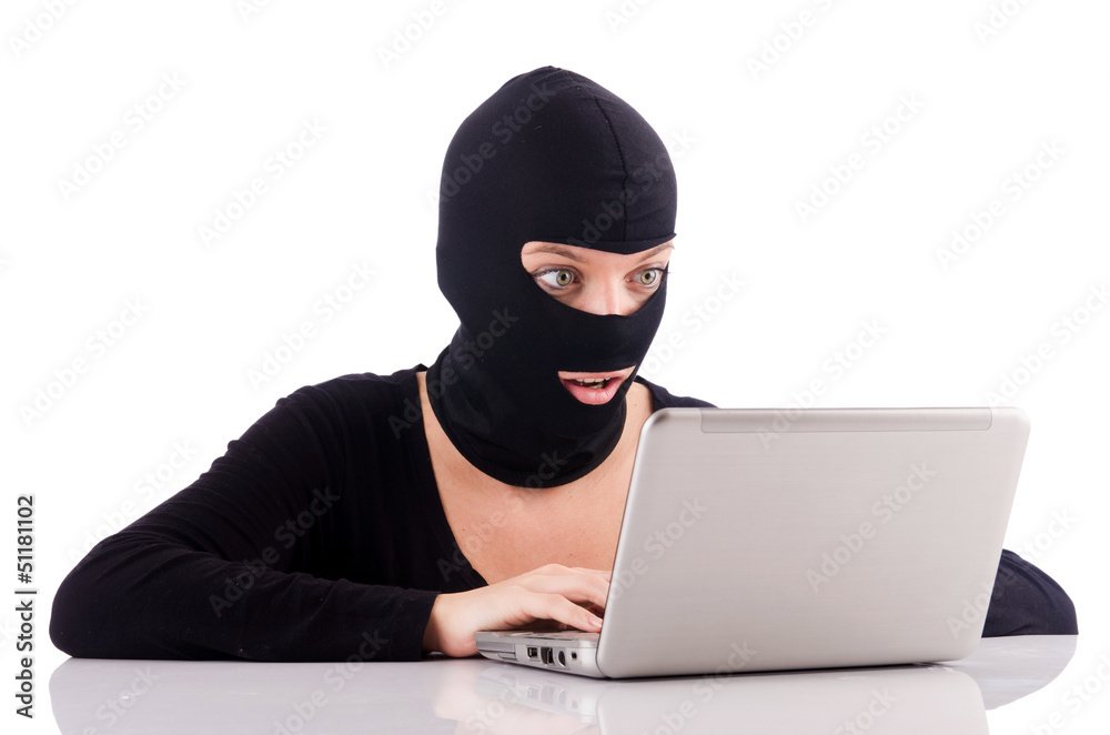 Hacker with computer wearing balaclava Hacker with computer wearing balaclava