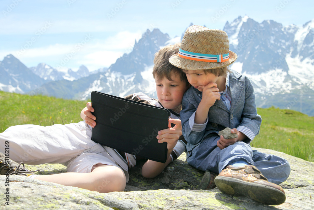 Two boys in Alps with touchpad