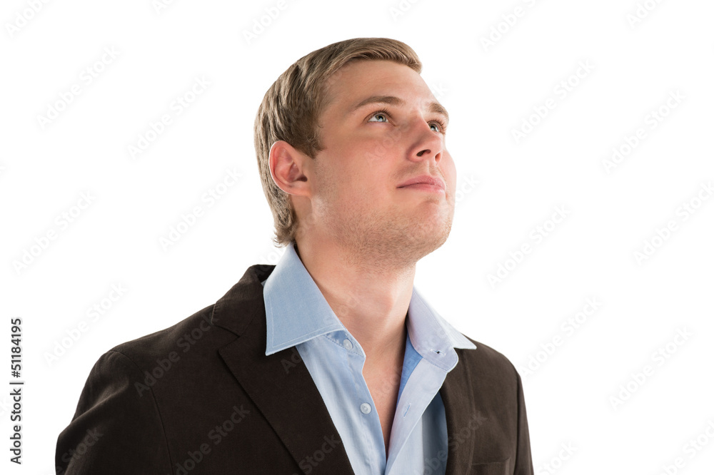 A thoughtful businessman looking up towards copyspace while isol A thoughtful businessman looking up towards copyspace while isol