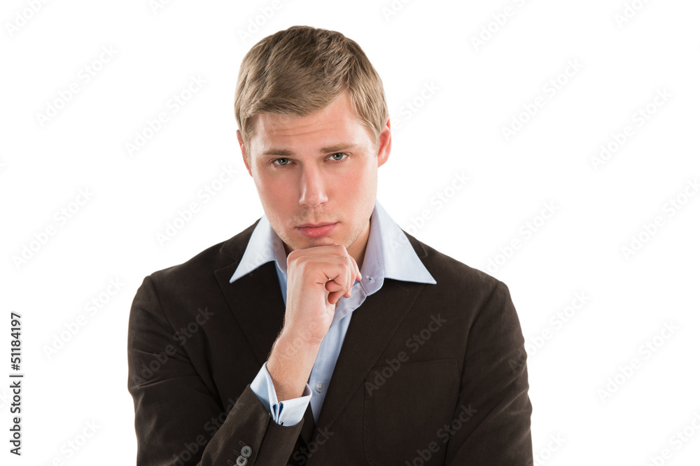 A thoughtful young executive gazing curiously at copyspace while