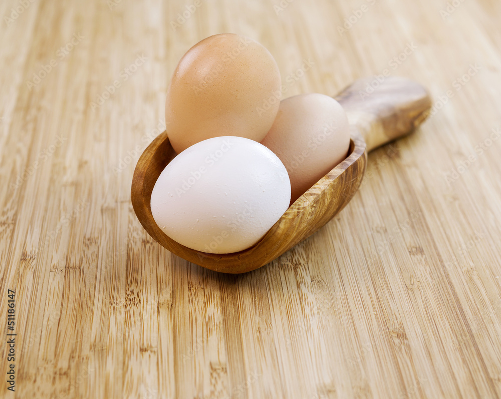 Whole Organic Eggs in Wooden Spoon Whole Organic Eggs in Wooden Spoon